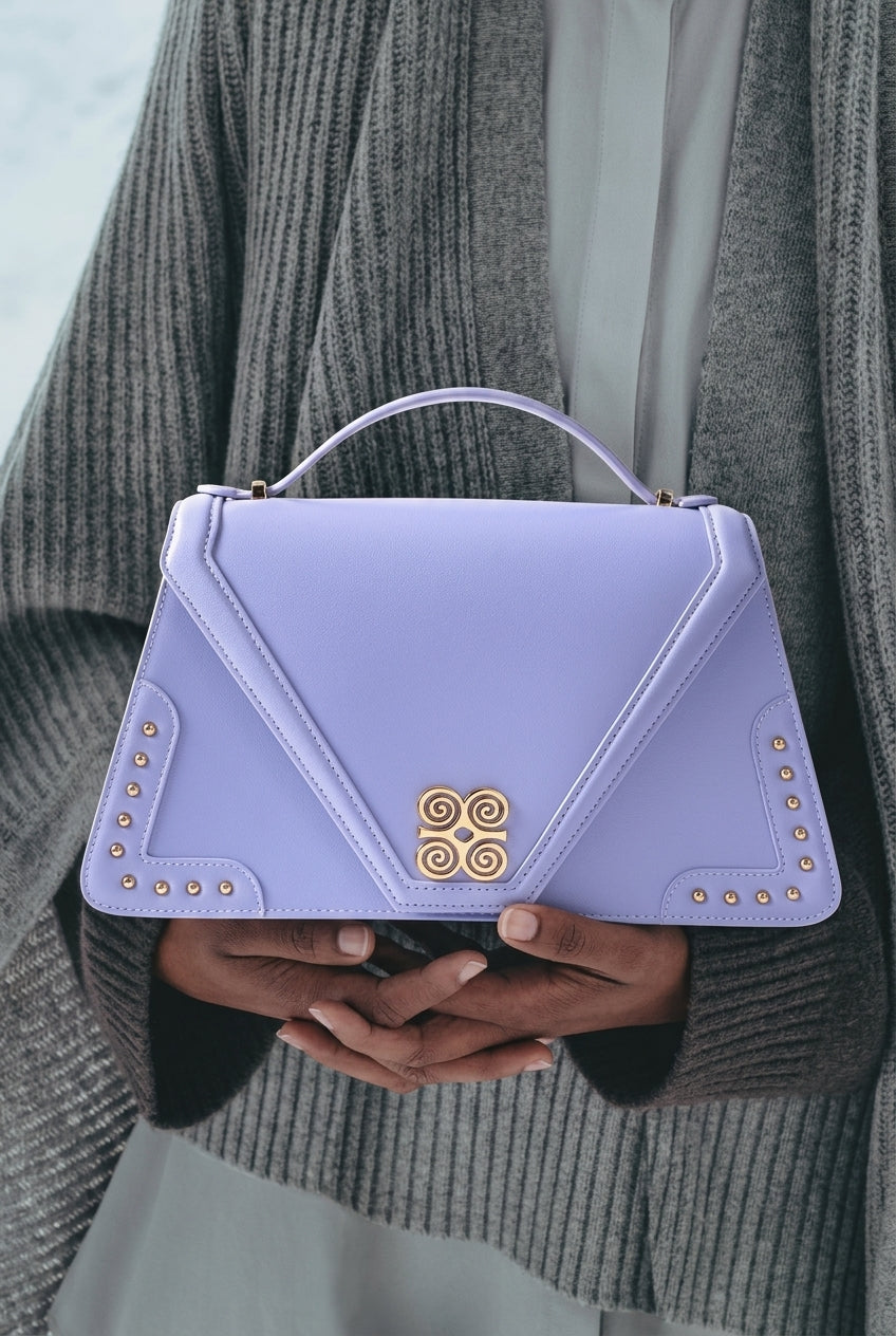 Sac à main Adinkra — pièce en cuir véritable clouté, Abidjan — Deveaux Paris